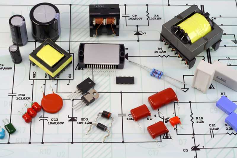 electronic components on top of printed schematic circuit diagram